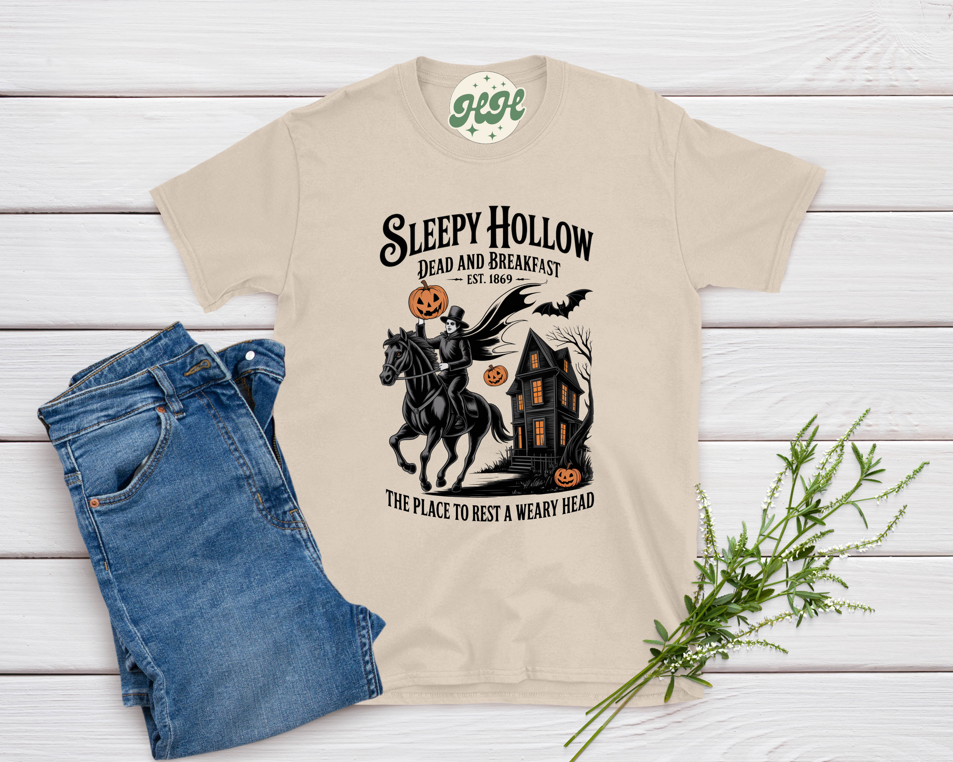 Beige Sleepy Hollow Bed and Breakfast Halloween shirt with Headless Horseman, haunted house, pumpkins, and bats