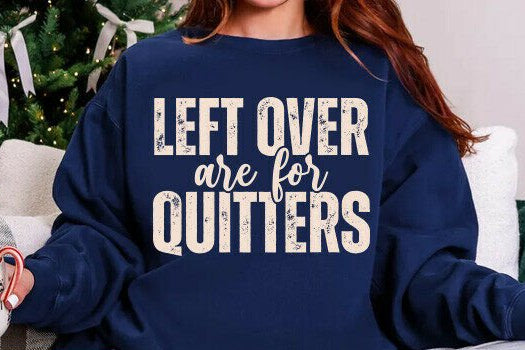 Person wearing a navy blue sweatshirt with 'LEFT OVER are for QUITTERS' text, sitting in a cozy room.