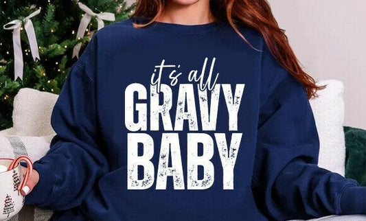 Person wearing a navy blue sweatshirt with 'it's all GRAVY BABY' text in a festive setting.